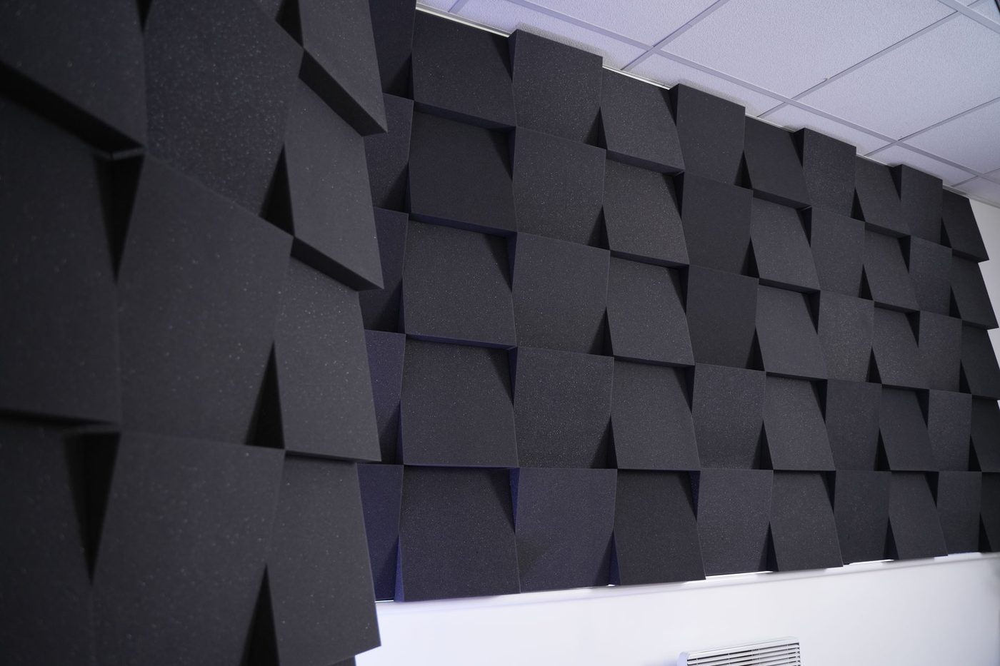 Black acoustic foam panels on the studio wall